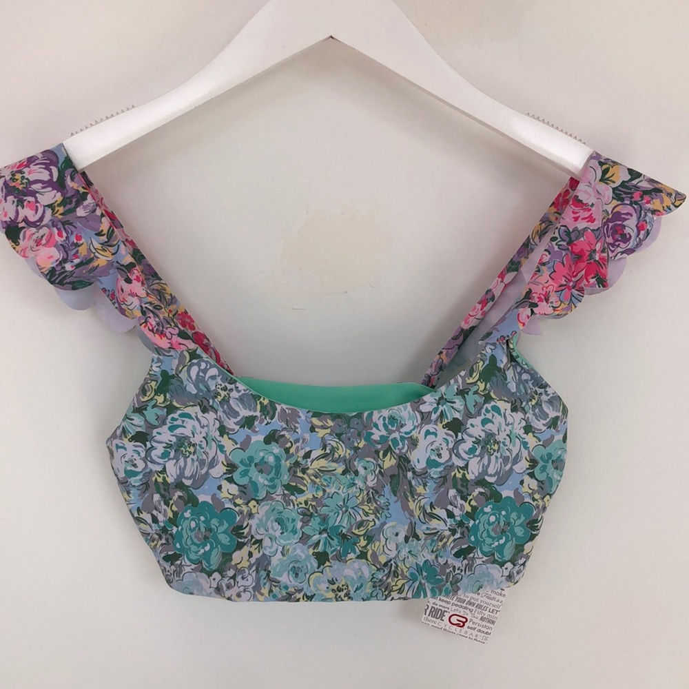 Beach Riot Womens Sports Top. Multicolored floral print with ruffled shoulder